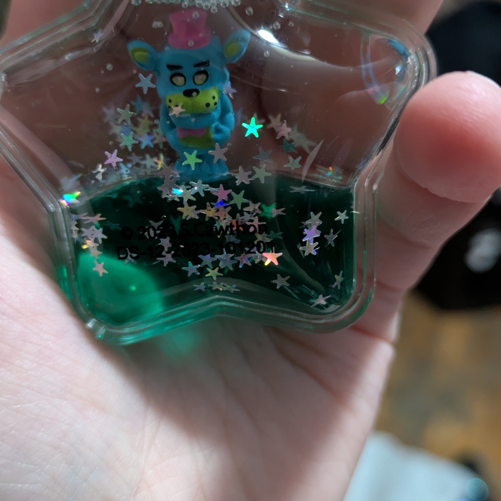 Star-Shaped Glitter Keychain with Blue Character